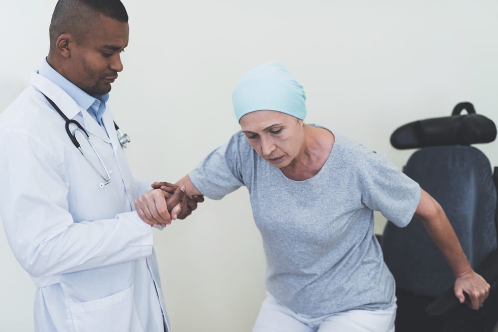 Doctor assisting a patient during a home consultation