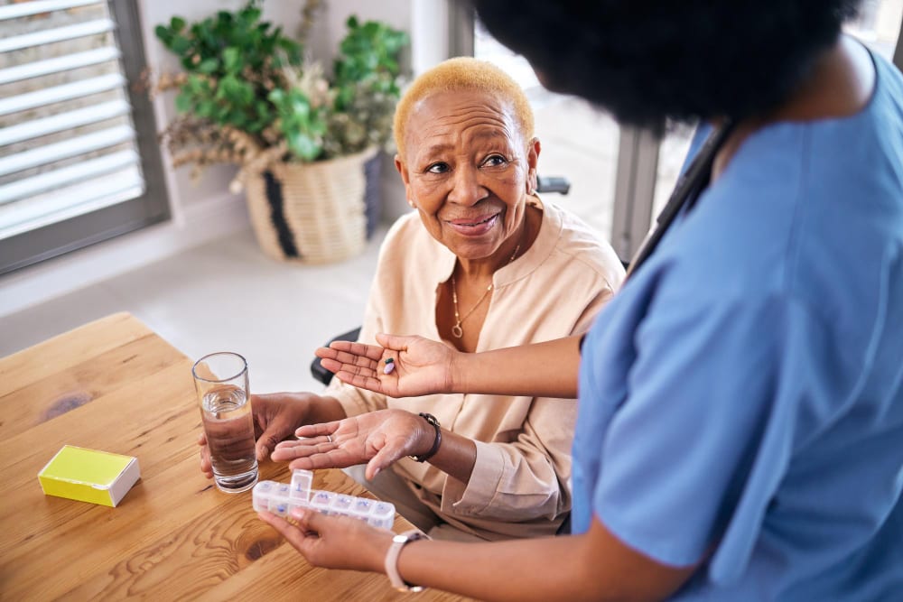 Caregiver discussing medication with a client at home